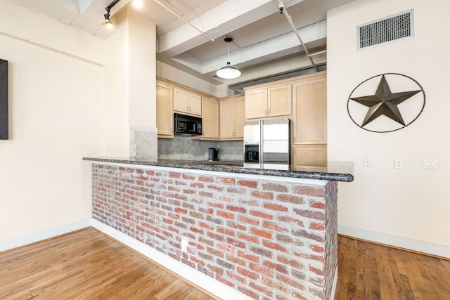 1120 Texas St Unit 7D, Houston, TX 77002 - kitchen with black microwave, stainless steel refrigerator with ice dispenser, light brown cabinets, baseboards, and beam ceiling