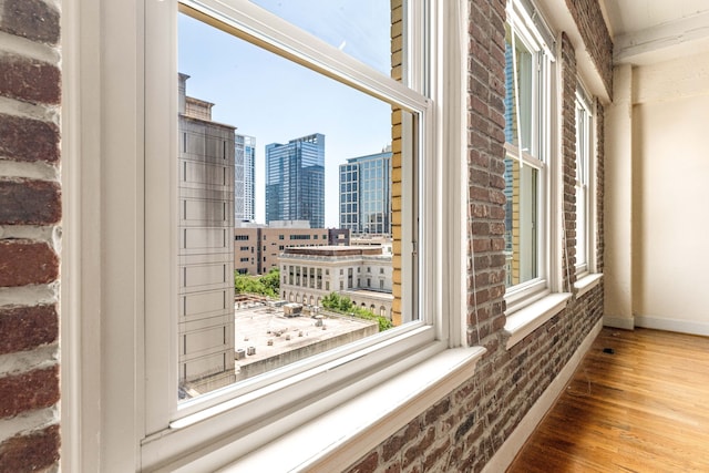 1120 Texas St Unit 7D, Houston, TX 77002 - detailed view of a view of city, brick wall, wood finished floors, and baseboards