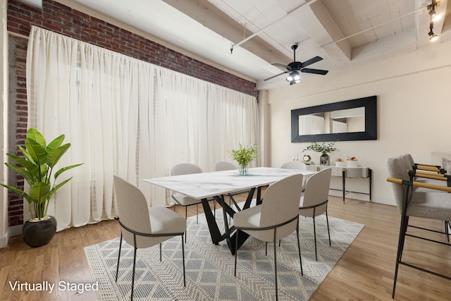 1120 Texas St Unit 7D, Houston, TX 77002 - dining room featuring brick wall, beamed ceiling, wood finished floors, and ceiling fan