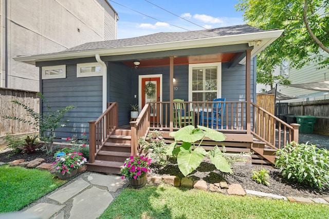 1710 Spring St, Houston, TX 77007 - view of front of property with fence, covered porch, and roof with shingles