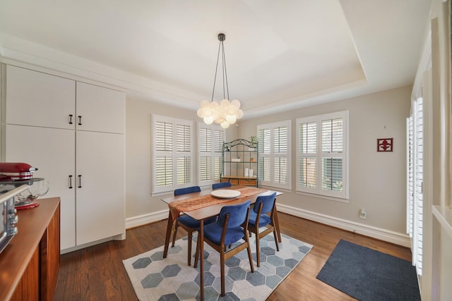 1710 Spring St, Houston, TX 77007 - dining room with a raised ceiling, a chandelier, dark wood-style floors, and baseboards