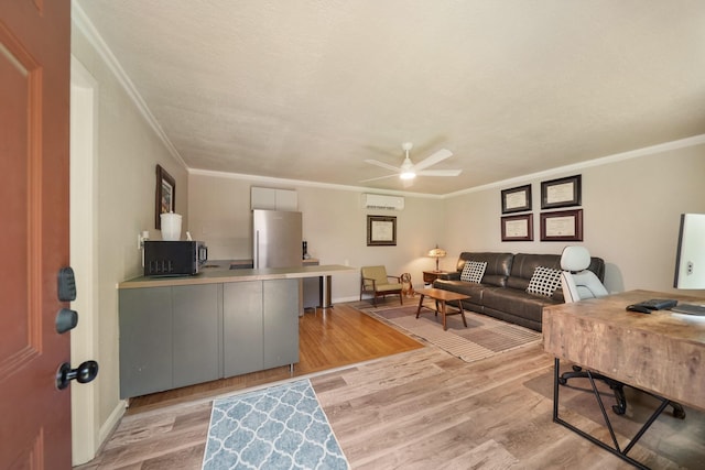 1710 Spring St, Houston, TX 77007 - living room with a wall unit AC, light wood finished floors, a ceiling fan, an office area, and crown molding