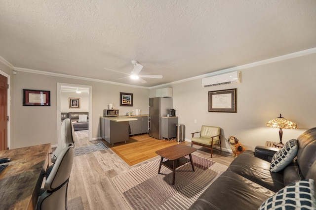 1710 Spring St, Houston, TX 77007 - living room with an AC wall unit, a textured ceiling, light wood-type flooring, ornamental molding, and ceiling fan