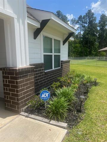 view of side of property with brick siding
