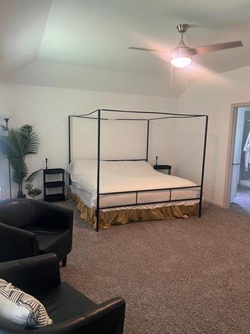 carpeted bedroom with lofted ceiling and ceiling fan
