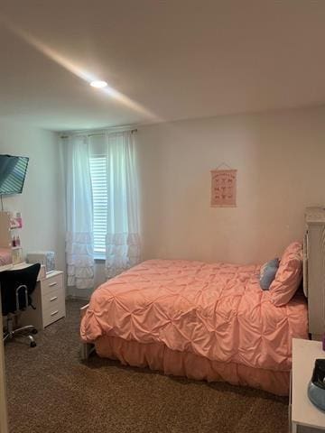 bedroom with dark colored carpet