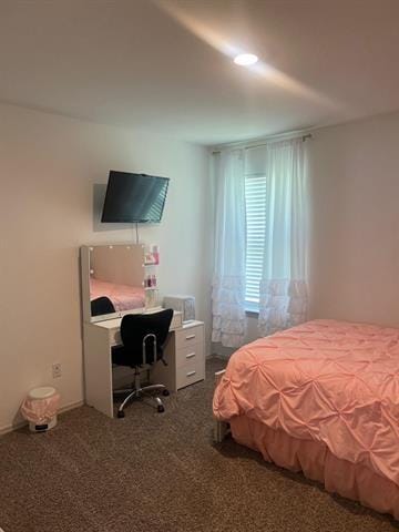 bedroom with a desk and carpet flooring