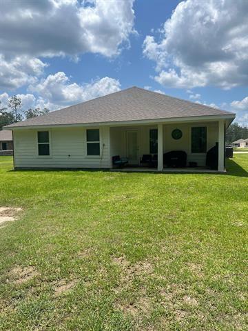 rear view of house with a yard
