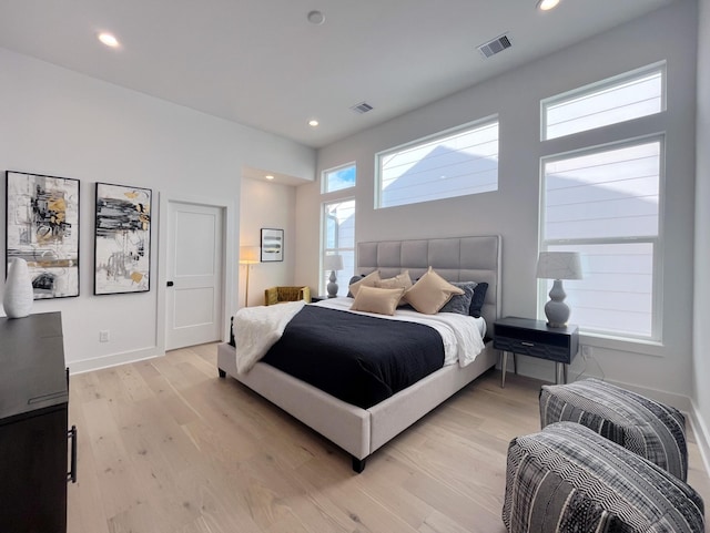 bedroom with light wood-style floors, recessed lighting, and baseboards