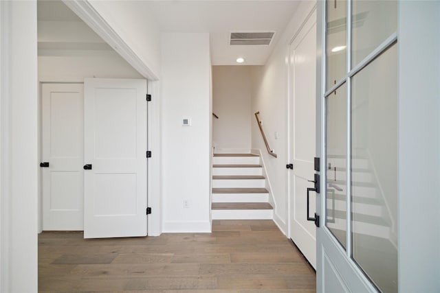entrance foyer with light wood-style floors, stairway, recessed lighting, and baseboards