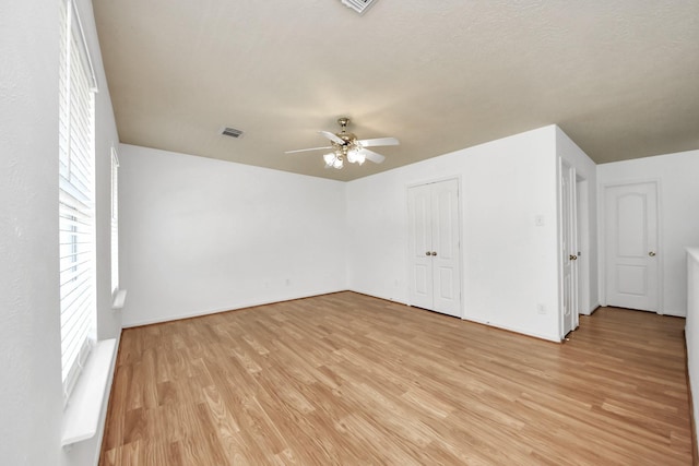 13114 Oak Ledge Dr, Houston, TX 77065 - unfurnished bedroom featuring light wood-style floors, ceiling fan, and a closet