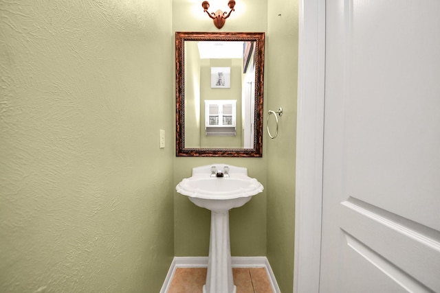 13114 Oak Ledge Dr, Houston, TX 77065 - bathroom featuring baseboards, tile patterned floors, and a textured wall