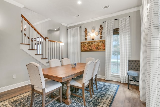 dining area with crown molding, baseboards, wood finished floors, stairs, and recessed lighting