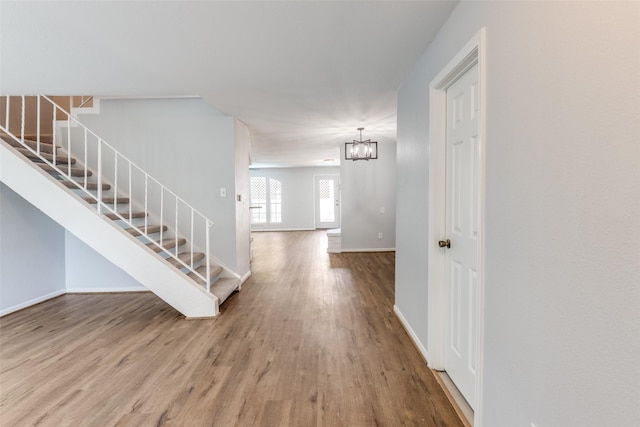 10816 Briar Forest Dr Unit 33, Houston, TX 77042 - entrance foyer with stairway, wood finished floors, a chandelier, and baseboards