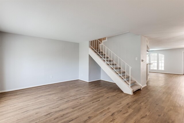 10816 Briar Forest Dr Unit 33, Houston, TX 77042 - unfurnished living room with wood finished floors, stairs, and baseboards