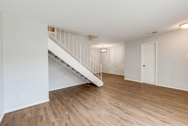 10816 Briar Forest Dr Unit 33, Houston, TX 77042 - unfurnished living room with stairs, wood finished floors, and baseboards