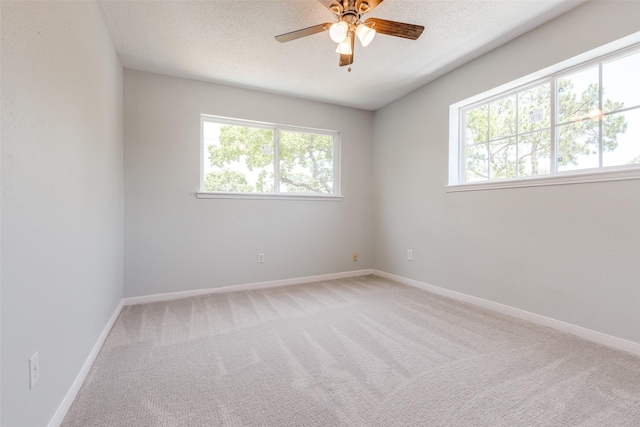 10816 Briar Forest Dr Unit 33, Houston, TX 77042 - spare room with ceiling fan, light carpet, baseboards, and a textured ceiling