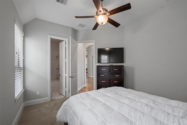 bedroom with baseboards, vaulted ceiling, carpet, ceiling fan, and ensuite bathroom