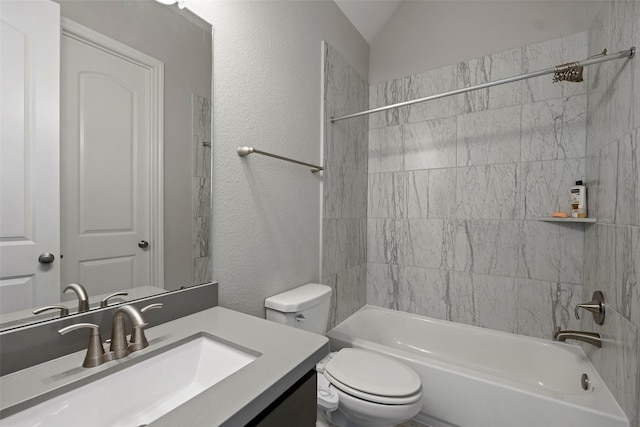 bathroom with a textured wall, toilet, washtub / shower combination, and vanity