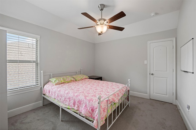 carpeted bedroom featuring baseboards and a ceiling fan