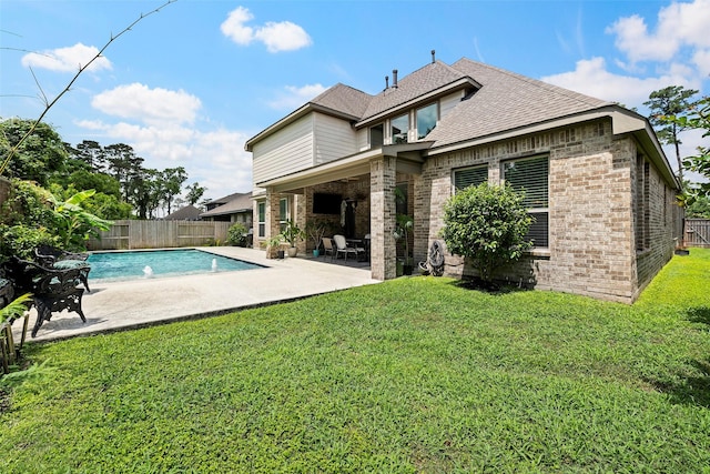 rear view of property with brick siding, a patio area, and a shingled roof