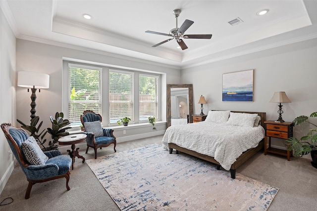 bedroom featuring a tray ceiling, carpet flooring, crown molding, baseboards, and recessed lighting