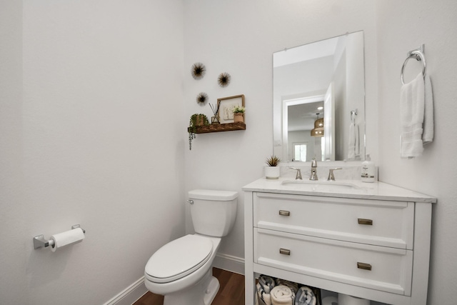 2003 Ballesteros St, Crosby, TX 77532 - half bathroom featuring toilet, wood finished floors, baseboards, and vanity