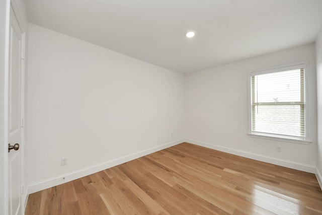 2003 Ballesteros St, Crosby, TX 77532 - empty room featuring baseboards, light wood finished floors, and recessed lighting