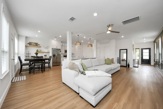 2003 Ballesteros St, Crosby, TX 77532 - living room featuring recessed lighting, light wood-style floors, ceiling fan, and baseboards