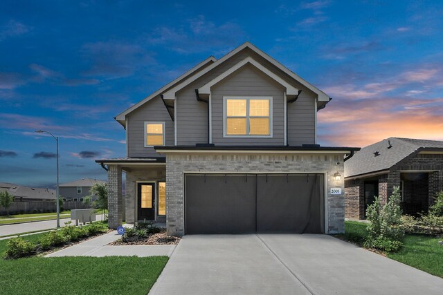 2003 Ballesteros St, Crosby, TX 77532 - traditional-style home with an attached garage, concrete driveway, brick siding, and a front lawn