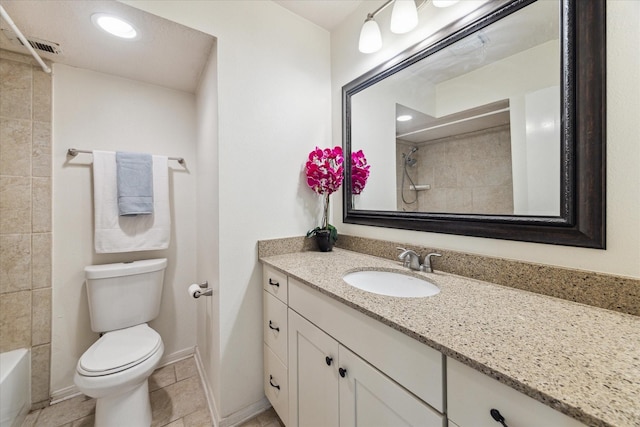 bathroom featuring toilet, vanity, baseboards, and recessed lighting