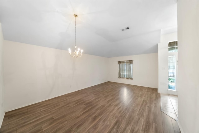 17922 Cypress Valley Ln, Cypress, TX 77429 - empty room featuring lofted ceiling, dark wood-type flooring, and a chandelier