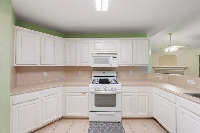 17922 Cypress Valley Ln, Cypress, TX 77429 - kitchen with white appliances, light tile patterned floors, light countertops, and white cabinets