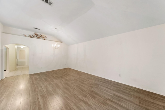 17922 Cypress Valley Ln, Cypress, TX 77429 - spare room featuring lofted ceiling, wood finished floors, a chandelier, and arched walkways