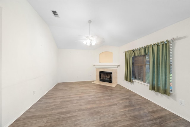 17922 Cypress Valley Ln, Cypress, TX 77429 - unfurnished living room with ceiling fan, a tile fireplace, wood finished floors, lofted ceiling, and baseboards