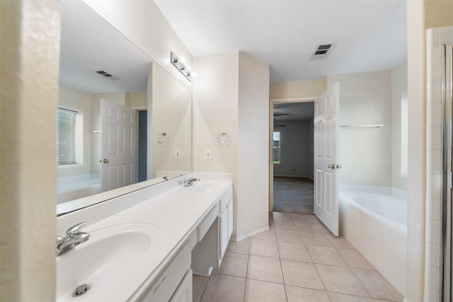17922 Cypress Valley Ln, Cypress, TX 77429 - bathroom with a bath, tile patterned floors, double vanity, and baseboards