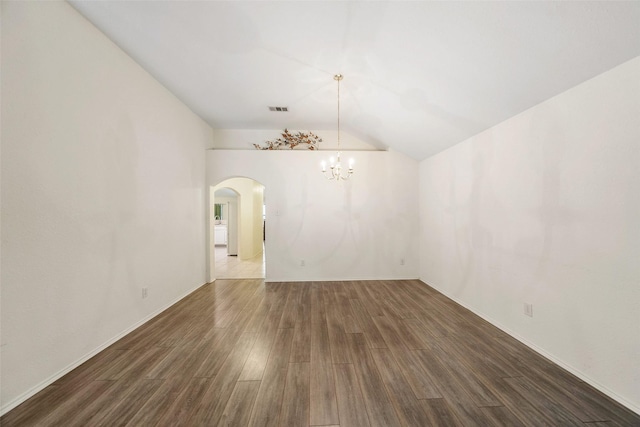 17922 Cypress Valley Ln, Cypress, TX 77429 - unfurnished dining area featuring a chandelier, wood finished floors, arched walkways, and lofted ceiling