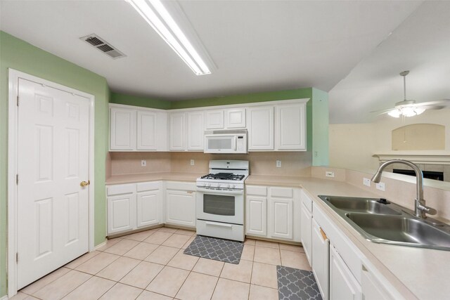 17922 Cypress Valley Ln, Cypress, TX 77429 - kitchen featuring white appliances, a sink, light tile patterned flooring, white cabinets, and light countertops