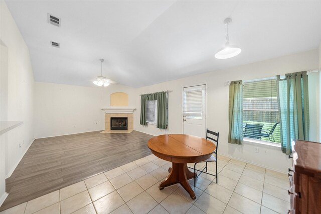 17922 Cypress Valley Ln, Cypress, TX 77429 - dining area featuring ceiling fan, a fireplace, light tile patterned floors, lofted ceiling, and baseboards