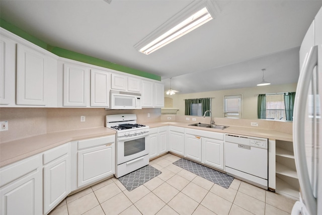 17922 Cypress Valley Ln, Cypress, TX 77429 - kitchen featuring white appliances, a sink, light countertops, white cabinets, and light tile patterned floors