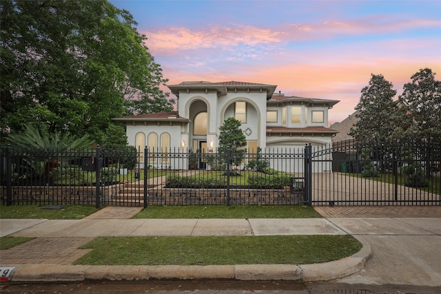 3109 Mcculloch Cir, Houston, TX 77056 - mediterranean / spanish-style home featuring decorative driveway, a fenced front yard, stucco siding, and a gate