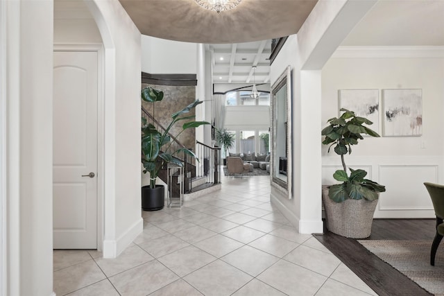 3109 Mcculloch Cir, Houston, TX 77056 - entryway featuring light tile patterned flooring, ornamental molding, and arched walkways