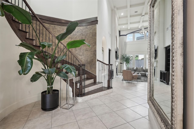 3109 Mcculloch Cir, Houston, TX 77056 - tiled entryway featuring a high ceiling, stairs, coffered ceiling, beamed ceiling, and recessed lighting