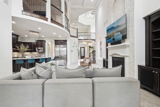 3109 Mcculloch Cir, Houston, TX 77056 - living area with a high ceiling, arched walkways, recessed lighting, a glass covered fireplace, and light tile patterned flooring