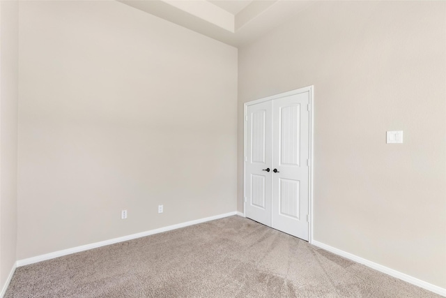 spare room with carpet and baseboards