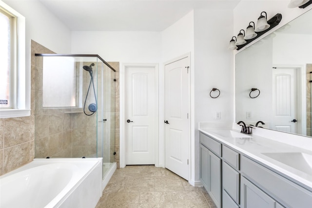 full bath featuring a stall shower, a bath, and double vanity
