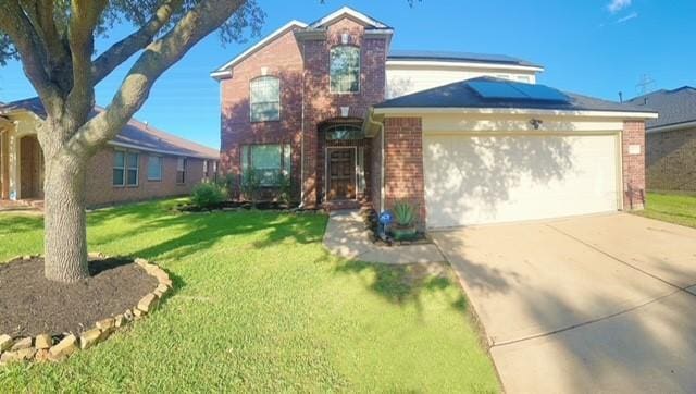 6514 Evening Rose Ln, Katy, TX 77449 - traditional-style house featuring brick siding, a garage, roof mounted solar panels, driveway, and a front yard
