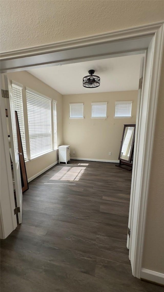 6514 Evening Rose Ln, Katy, TX 77449 - unfurnished dining area featuring dark wood-style flooring and baseboards