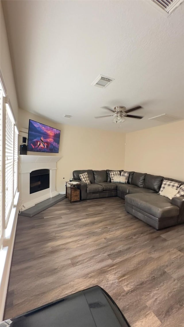 6514 Evening Rose Ln, Katy, TX 77449 - living area with wood finished floors, a fireplace with raised hearth, and a ceiling fan
