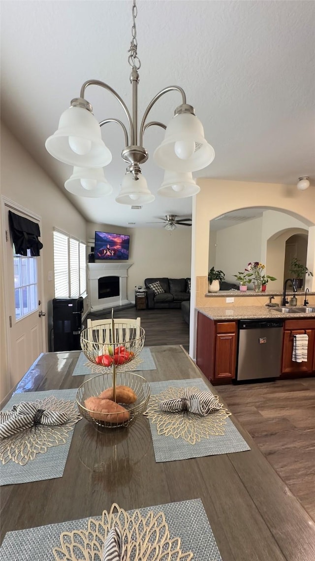 6514 Evening Rose Ln, Katy, TX 77449 - living room with arched walkways, wood finished floors, and a fireplace